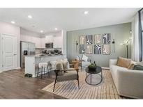 Bright and airy living room showcasing modern decor and an open concept connecting to the kitchen at 1402 Sweetshrub Pl # 32, Atlanta, GA 30318