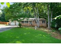 Charming single-story home with a well-maintained lawn and a two-car garage at 5070 Maryland Nw Dr, Acworth, GA 30101