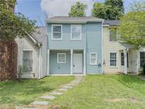 Charming two-story home with light blue vinyl siding and a well-manicured front lawn at 2391 Cove Rd, Lithonia, GA 30058