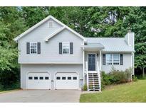 Charming two-story home with light-gray siding, black shutters, and a well-maintained two-car garage at 50 Old Oak Trce, Dallas, GA 30157