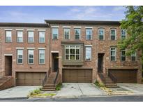 Charming brick townhomes featuring attached garages and inviting staircases at 2442 Crescent Park Ct, Atlanta, GA 30339
