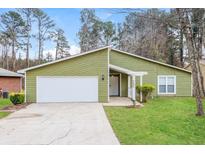 Charming one-story home with green siding, white trim, and well-maintained front yard at 2695 Trotters Walk Trl, Snellville, GA 30078