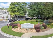The Granville Condominium Homes exterior grounds features beautiful landscaping and mature shade trees at 620 Granville Ct, Sandy Springs, GA 30328