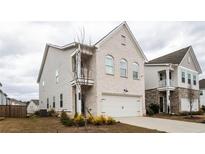 Charming two-story white brick home features a balcony and attached two-car garage at 3739 Silvery Way, Powder Springs, GA 30127