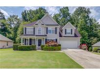 Charming two-story home with a well-manicured lawn, trimmed hedges, and a two-car garage at 658 Eight Point Ct, Suwanee, GA 30024