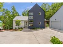 Striking modern home with a unique two-tone facade and well-manicured landscaping at 160 Cedarwood Ln, Roswell, GA 30075