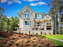 Charming two-story home with a brick facade and a well-manicured front yard at 1005 Liberty Springs Dr, Woodstock, GA 30188