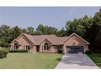 Charming brick home with a well-manicured lawn and a two-car garage at 180 Jay Trl, Fayetteville, GA 30215