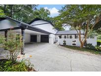 Beautiful two-story home with a white brick fence, two car garage and mature trees at 464 Rockborough Ter, Stone Mountain, GA 30083