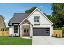 Charming two-story home features a stone-accented entrance, a garage with horizontal windows and a well-manicured lawn at 1780 Aircraft Se Dr, Marietta, GA 30060