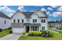 Charming two-story home with a landscaped yard, brick accents and a two car garage at 3695 Andover St, Cumming, GA 30028