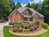 Beautiful brick home featuring manicured landscaping and a welcoming front entrance at 4850 Boulder Stone Way, Auburn, GA 30011
