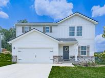 Charming two-story home featuring a 2 car garage, brick accents, a manicured lawn, and decorative shutters at 520 Pemberton St, Euharlee, GA 30145