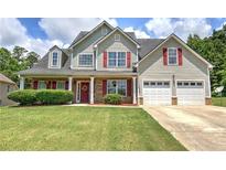 Charming two-story home featuring red shutters, a well-manicured lawn, and an attached two-car garage at 524 Birchwood Dr, Temple, GA 30179