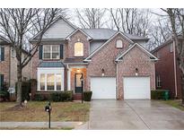 Charming brick home featuring an attached two car garage and well-manicured landscaping at 6674 Mimosa Cir, Tucker, GA 30084