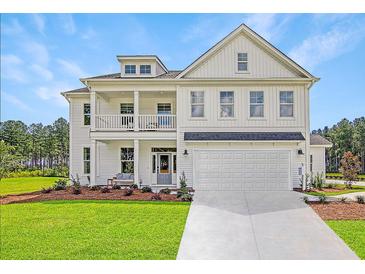 Two-story farmhouse with white siding, a large driveway, and landscaping at 173 Fiddleback Dr, Summerville, SC 29486
