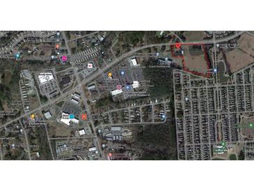 Aerial view showing a large lot near residential homes and businesses at 1501 Central Ave, Summerville, SC 29483