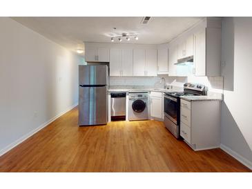 Modern kitchen with stainless steel appliances and wood flooring at 40 Bee St # 111, Charleston, SC 29403