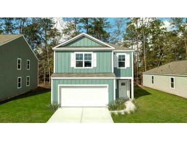 Charming two-story home featuring vertical siding, crisp white trim, and a manicured front lawn at 2163 Macallan Blvd, Ravenel, SC 29470