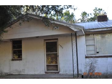 Ranch style home with metal roof and mature trees at 2475 Wire Rd, Saint George, SC 29477