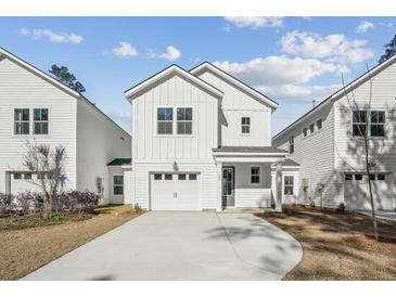 Two-story white farmhouse-style home with driveway and landscaping at 325 Chapman Cir, Goose Creek, SC 29445