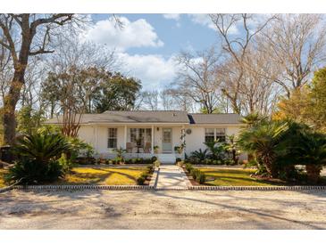 Charming white brick ranch home with landscaped yard and walkway at 1466 Glencoe St, Mount Pleasant, SC 29464