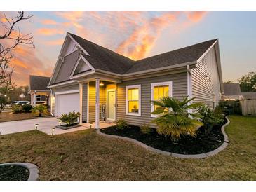 Charming craftsman style home with gray siding, welcoming porch and landscaped yard at 1627 Shady Pine Rd, Charleston, SC 29414