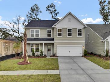 Two-story house with gray siding, white garage door, and landscaped lawn at 2018 Quiet Ibis Rd, Hanahan, SC 29410