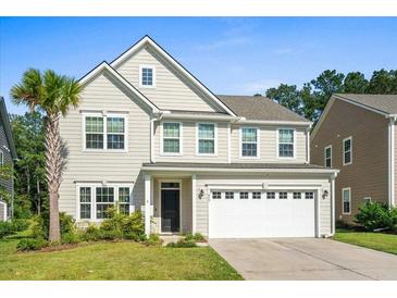 Two-story house with a white garage door and landscaping at 440 Coopers Hawk Dr, Summerville, SC 29483