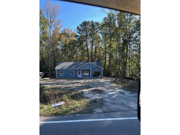 Newly constructed home with gray siding and pink accents at 6209 Drayton St, Ravenel, SC 29470