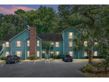 Evening view of a charming two-story light green building with ample parking at 6240 April Pine Cir # B, North Charleston, SC 29406