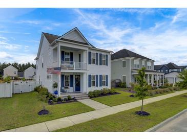 Two-story home with white siding, blue shutters, and a front porch at 645 Blueway Ave, Summerville, SC 29486