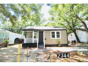 Charming renovated bungalow with a front porch and landscaped yard at 2744 E Surrey Dr, North Charleston, SC 29405