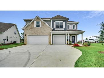 Two-story house with gray siding, brick accents, and a two-car garage at 121 Crosscut Ln, Summerville, SC 29486