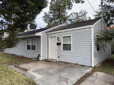 Gray house with a small front porch and a yard at 2351 Elegans Dr, North Charleston, SC 29405