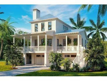 Two-story home with a metal roof, porch, and two-car garage at 6045 Honey Hole Haven, Johns Island, SC 29455