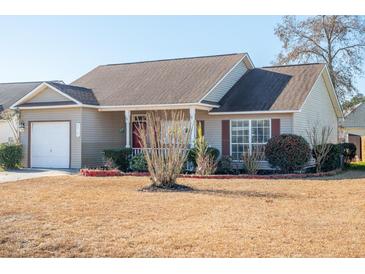 Tan house with brown roof, white garage door, and small front porch at 8419 Creekstone Ct, North Charleston, SC 29406