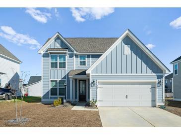 Two-story home with blue siding, white trim, and a two-car garage at 467 Eagleview Drive, Moncks Corner, SC 29461