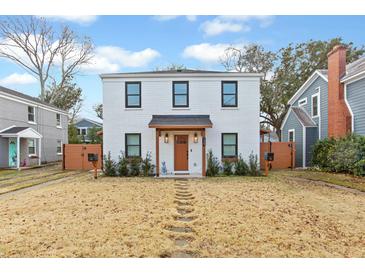 Two-story white brick home with modern accents and a manicured lawn at 139 Gordon St, Charleston, SC 29403