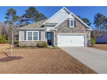 One-story home with stone accents and a two-car garage at 1040 Wading Point Blvd, Huger, SC 29450