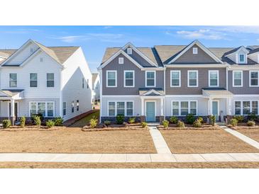 Two-story townhouses with gray and white siding, landscaping, and walkways at 240 Godwit Dr, Summerville, SC 29486
