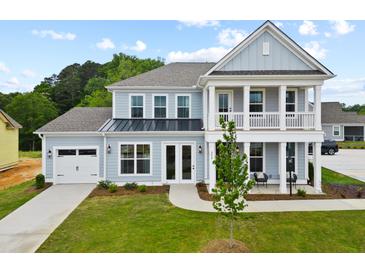 Two-story home with light blue siding, white trim, and a front porch at 351 Wappoo Trace Ln, Summerville, SC 29486