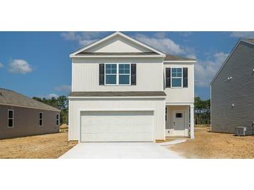 Two-story house with white siding, black shutters, and a white garage door at 730 Long Bluff Rd, Summerville, SC 29486
