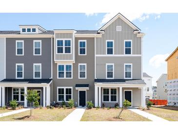 Two-story townhome with gray siding, white trim, and a front porch at 803 Recess Pointe Dr # 54, Moncks Corner, SC 29461