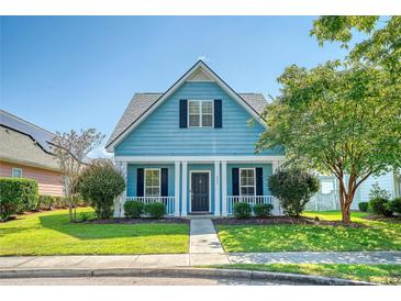 Charming light blue house with a front porch, landscaping, and walkway at 307 Pimpernel St, Summerville, SC 29483