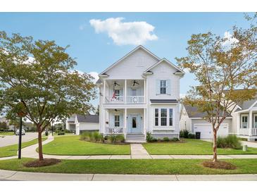 Two-story white house with light blue accents, a front porch, and a landscaped lawn at 1617 Bowsprit Ct, Mount Pleasant, SC 29466