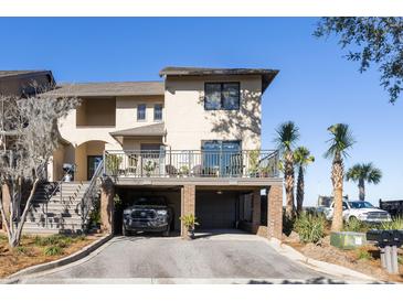 Two-story townhome with attached garage and deck, offering charming curb appeal at 1915 Marsh Oak Ln, Seabrook Island, SC 29455
