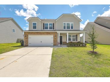 Two-story house with stone accents, a front porch, and a well-maintained lawn at 238 Wathen Dr, Goose Creek, SC 29445
