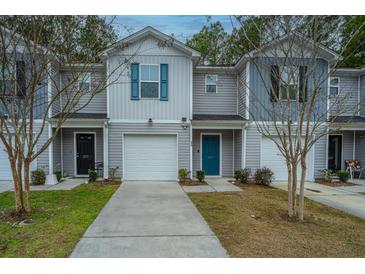 Gray townhouses with teal doors and white garages at 275 Jackson St, Goose Creek, SC 29445
