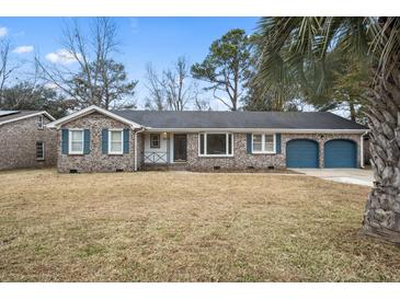 Brick ranch house with attached garage and landscaped lawn at 8626 Vistavia Rd, North Charleston, SC 29406